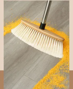 Bamboo broom with soft bristles and stainless steel handle for effective wood floor cleaning.