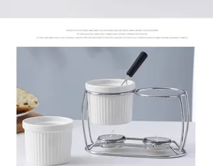 Ceramic butter warmer and chocolate cheese fondue set with metal stand and candles detail.