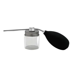 Molecular gastronomy powder spray bottle detail, glass jar with metal nozzle and bulb.