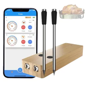 Wireless Bluetooth meat thermometer with wooden charging base and dual stainless steel probes for kitchen BBQ.