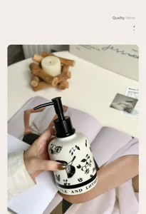 Ceramic soap dispenser detail showcasing black and white floral pattern and pump mechanism.