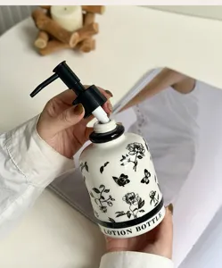 Ceramic lotion dispenser bottle with floral and butterfly pattern for bathroom pump use.