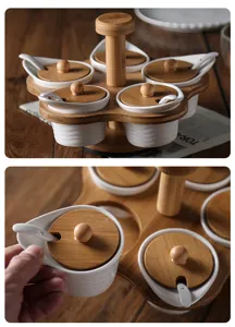 Rotating ceramic seasoning jar set with wooden lids, spoons and bamboo stand for home.