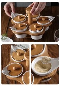 Rotating ceramic spice jar set with bamboo rotating base, lids and spoons for kitchen storage.