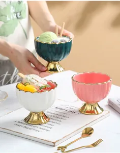 Ceramic ice cream dessert bowl with gold high foot and elegant scalloped rim for sweet treats.