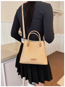 Beige leather bucket handbag and stylish shoulder crossbody bag showcasing fine details