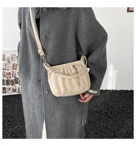Beige gathered shoulder bag with metal chain detail, stylish chic design for daily commuting.