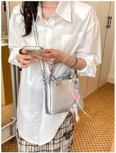Silver woven shoulder bag for women, stylish metallic top handle crossbody bag detail.