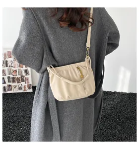 Beige ruched shoulder bag detail shot, stylish crossbody design featuring metal star zipper.