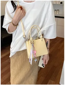 Stylish woven bucket bag for women, chic leather shoulder crossbody bag with knot handle.
