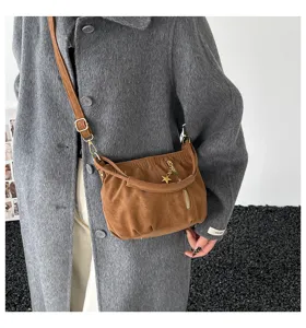 Trendy brown slouchy shoulder crossbody bag, stylish commuter leather handbag with star charm.
