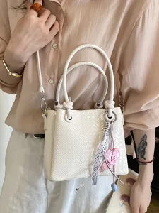 Stylish women woven bucket bag with top handles and shoulder strap for daily commute.