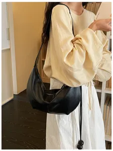 Classic black leather hobo shoulder bag for women, stylish underarm dumpling design.