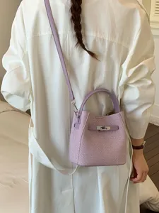 Chic purple bucket bag for women, stylish crossbody shoulder handbag with top handle.