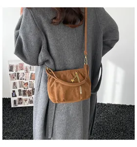 Detailed view of a brown casual shoulder and crossbody bag with stylish star charm.