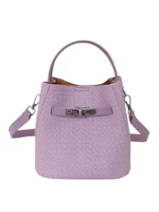 Light purple woven bucket bag with top handle and shoulder strap, chic metal lock design.