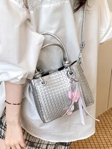 Silver woven bucket bag stylish shoulder crossbody bag with metallic finish and cute charms.