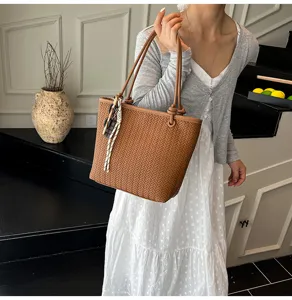 Detailed view of the casual woven tote bag, showcasing texture and stylish shoulder design.