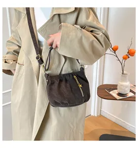 Detailed view of the dark brown gathered shoulder bag featuring a chic star zipper pendant.