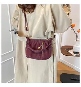Wine red ruched crossbody bag with star charm, stylish soft leather shoulder bag for women.