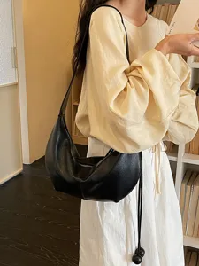 Black leather shoulder bag for women, casual slouchy dumpling hobo design, stylish underarm handbag daily use.