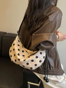 Chic polka dot shoulder bag for women, trendy underarm hobo dumpling handbag with stylish strap.
