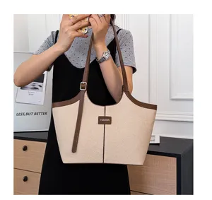 Women's chic beige canvas tote bag with brown leather trim, large capacity commuter shoulder bag.