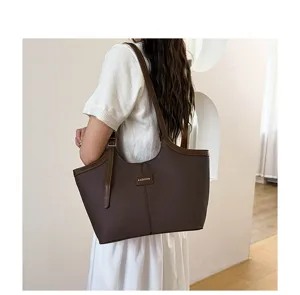 Detailed view of the elegant brown leather shoulder tote bag, perfect for daily commute work.