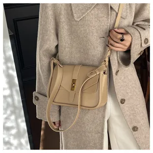 Close-up detail shot of the elegant beige leather crossbody messenger bag with metallic clasp.