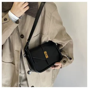 Black vintage shoulder bag detail showing soft leather texture and chic gold hardware lock.