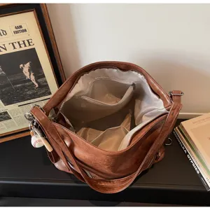 Brown PU leather shoulder tote bag interior detail, spacious casual handbag with pockets.