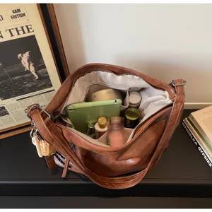 Brown PU leather commuter tote bag inner capacity detail showing multiple storage compartments.
