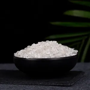 Polished natural white crystal quartz stones in a decorative black bowl for home
