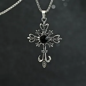 Close-up view of a Gothic punk cross pendant with a faceted black gemstone and chain