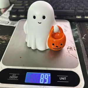 Detailed view of a cute resin Halloween ghost figurine on a scale showing a weight of 89 grams