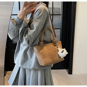 Women fashion casual brown bucket bag with plush pendant, stylish shoulder tote bag for daily.