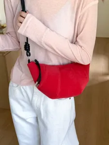 Red suede croissant crossbody bag for women, stylish minimalist dumpling shoulder bag.