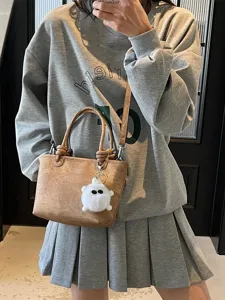 Stylish brown PU leather bucket bag for women, versatile daily crossbody bag with charm.