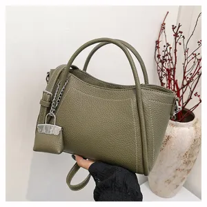 Olive green leather handbag detail, stylish casual tote with lock charm and chain, ideal for daily commute.
