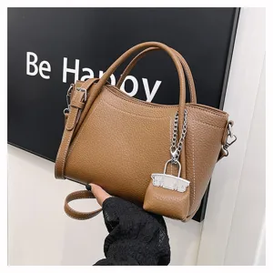 Stylish brown leather handbag for women, large capacity shoulder bag with chic mini charm.