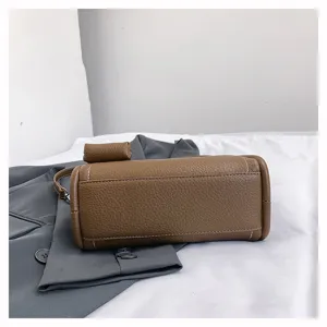 Detail shot of the brown leather pillow bag with fine stitching, elegant daily accessory.
