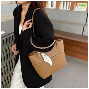 Brown tote bag detail view, casual shoulder bag with scarf decoration, stylish daily commuting.