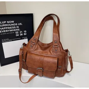 Retro brown PU leather tote bag detail showcasing multiple pockets, straps and hardware.