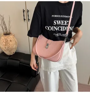Chic pink textured shoulder bag for women, trendy underarm saddle bag for daily commute.