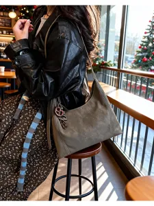 Detailed view of the vintage grey hobo shoulder bag in a cozy cafe setting with daily style.