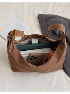 Detailed view of the large capacity retro brown shoulder bag showcasing its spacious interior.