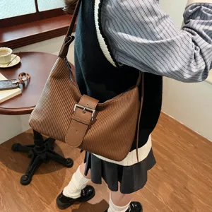 Vintage brown pleated shoulder bag for women, stylish buckle crossbody commuting bag.