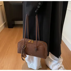 Detailed view of the brown vintage underarm shoulder bag with twin straps and zipper closure.