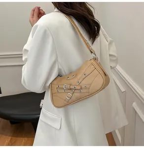 Beige motorcycle shoulder bag, PU leather buckle strap design, stylish retro armpit bag detail view.