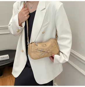 Beige leather motorcycle shoulder bag detailed view, featuring buckle and stud accents.
